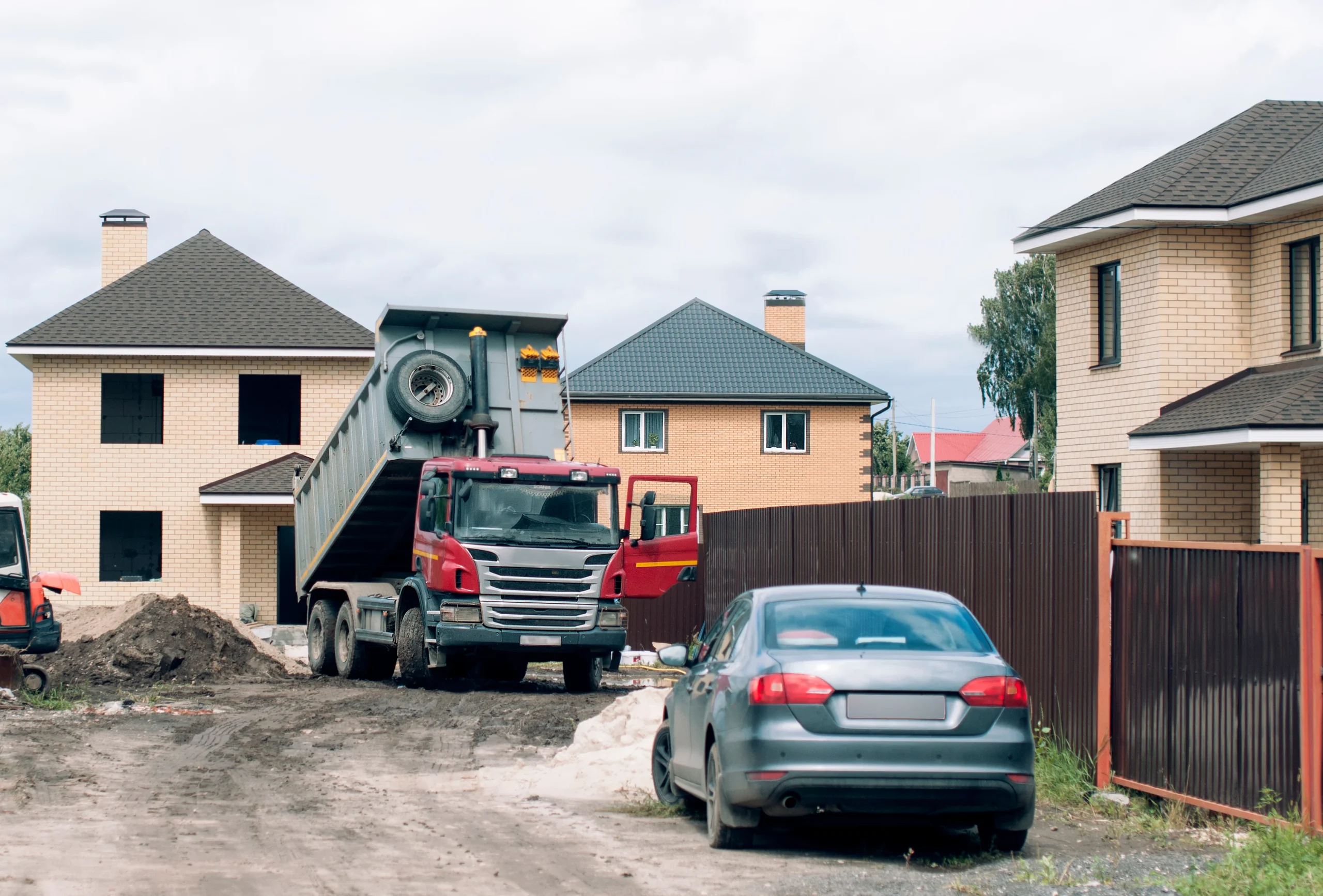 Construction of houses in the private sector. A truck unloads construction materials